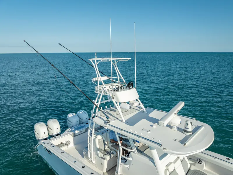 Slide: The Image of 2023 Invincible 37 Catamaran on open sea, featuring multiple outboard engines and fishing rods. - 21