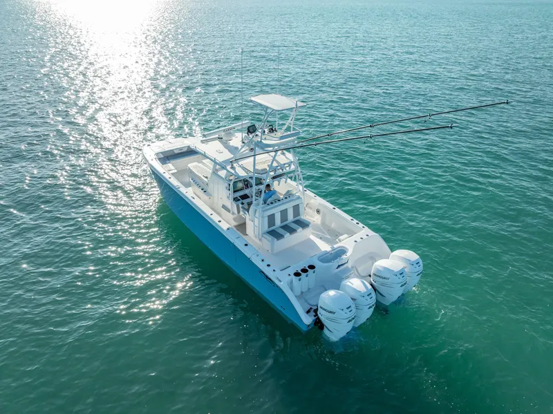 Slide: The Image of 2023 Invincible 37 Catamaran on serene ocean waters, showcasing sleek design and powerful engines. - 24