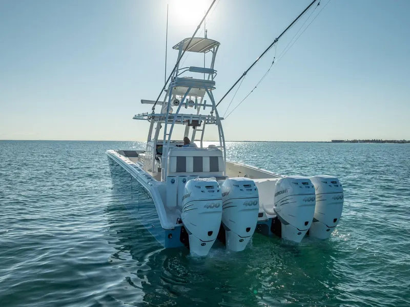 Slide: The Image of 2023 Invincible 37 Catamaran with four engines on open water, rear view. - 27