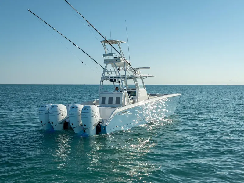 Slide: The Image of 2023 Invincible 37 Catamaran on open water, featuring triple outboard engines. - 29