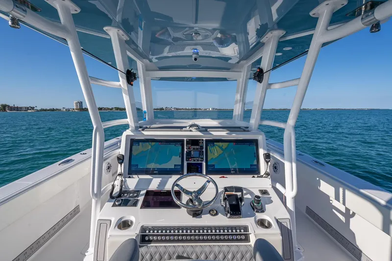 Slide: The Image of 2023 Invincible 37 Catamaran helm with advanced navigation systems on open water. - 30