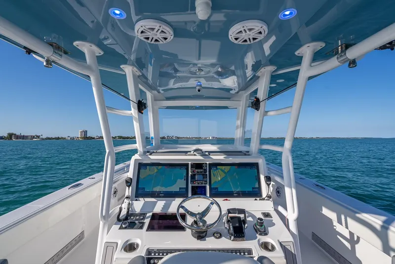 Slide: The Image of 2023 Invincible 37 Catamaran cockpit with advanced navigation systems on open water. - 31