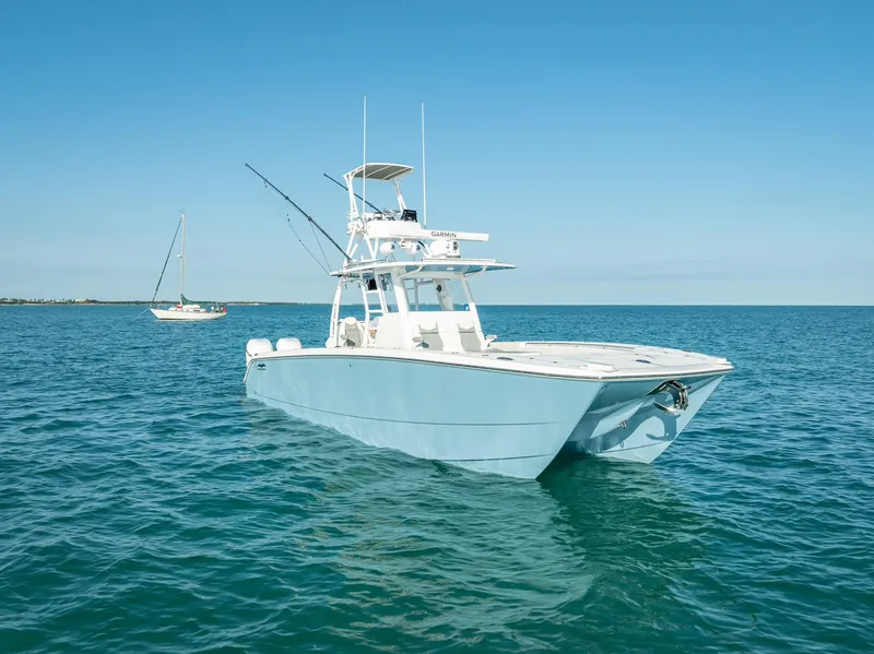 Slide: The Image of 2023 Invincible 37 Catamaran on calm blue ocean waters under clear sky. - 4