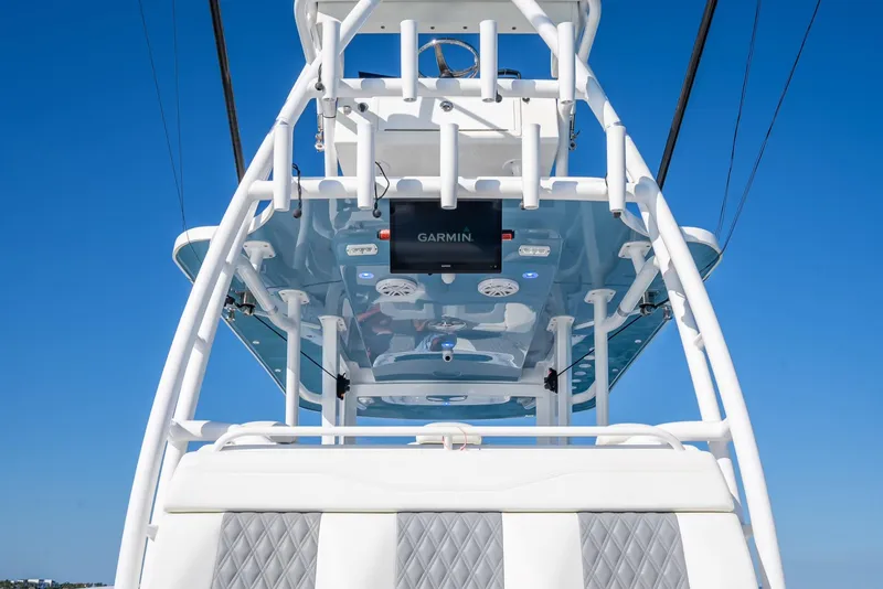 Slide: The Image of 2023 Invincible 37 Catamaran helm with Garmin electronics against clear blue sky. - 40
