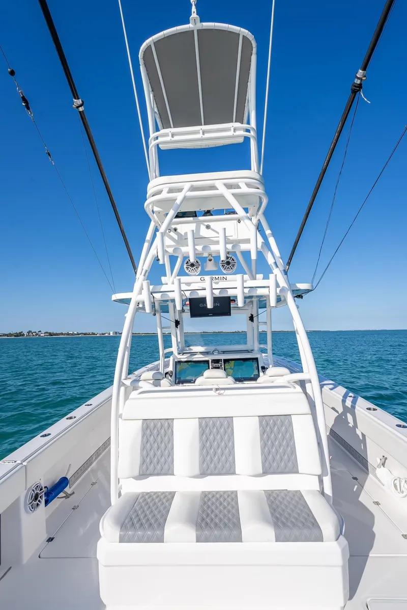 Slide: The Image of 2023 Invincible 37 Catamaran with tower, on calm blue waters under clear sky. - 41