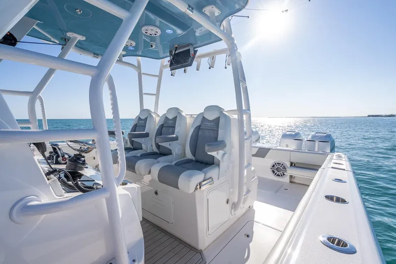 Slide: The Image of 2023 Invincible 37 Catamaran interior with seating, ocean view, and sunlight. - 44