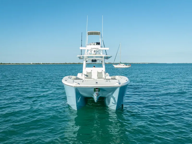 Slide: The Image of 2023 Invincible 37 Catamaran on calm blue waters, front view. - 5