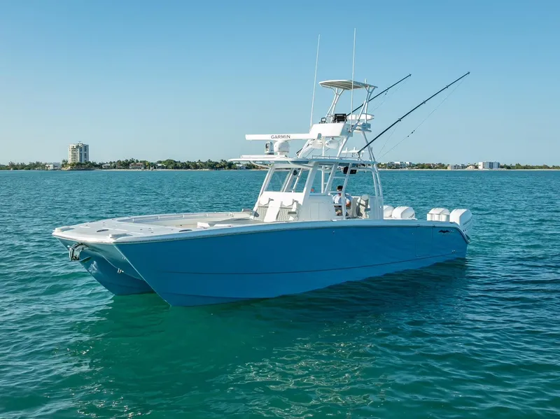 Slide: The Image of 2023 Invincible 37 Catamaran on clear blue water, showcasing sleek design and modern features. - 7