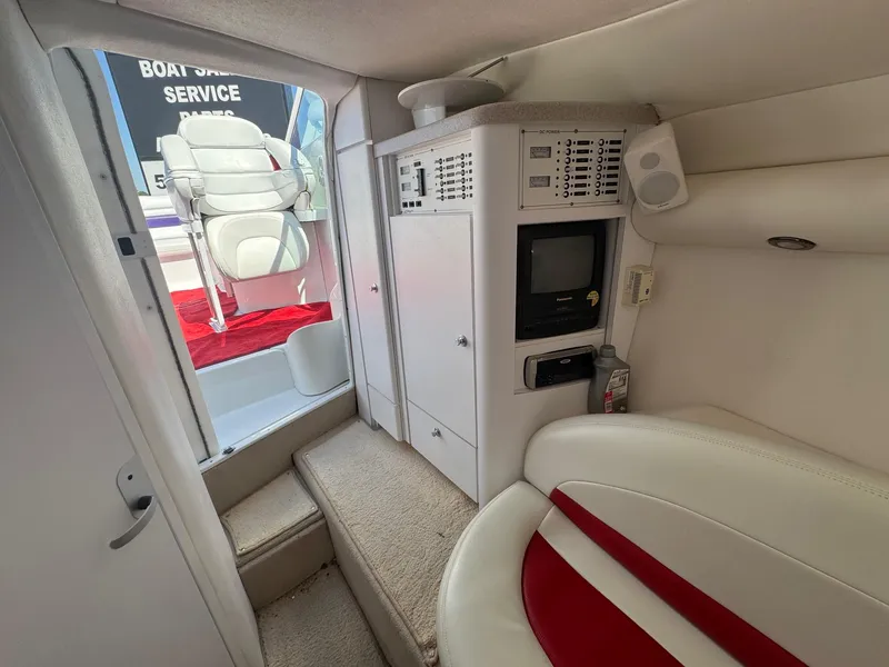 Slide: The Image of Interior of a 2002 Baja .38 Special boat with white and red seating. - 10