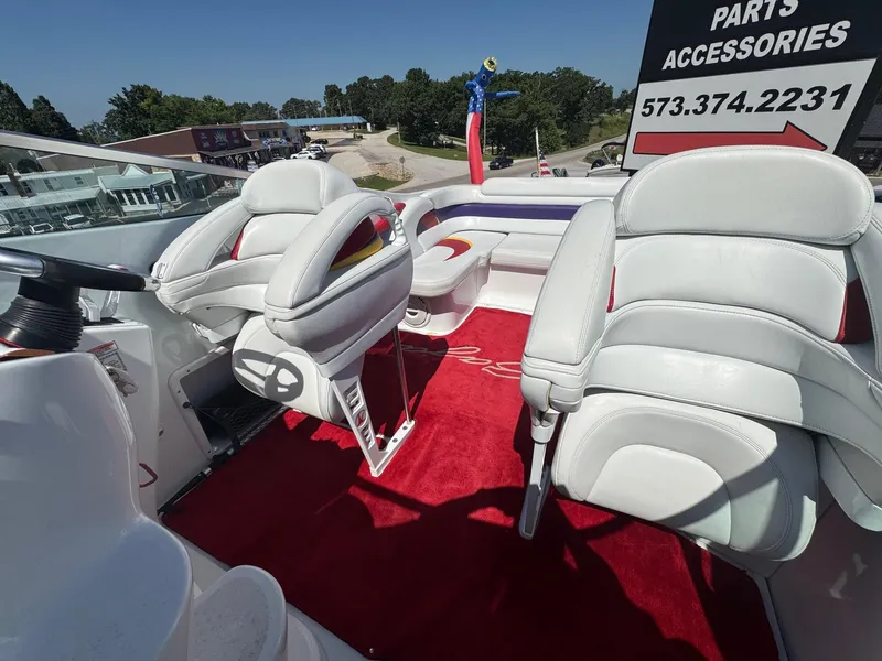 Slide: The Image of Interior of a 2002 Baja .38 Special boat with white seats and red carpet. - 11