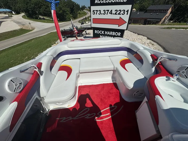 Slide: The Image of Interior of a 2002 Baja .38 Special boat with red and white seating. - 12