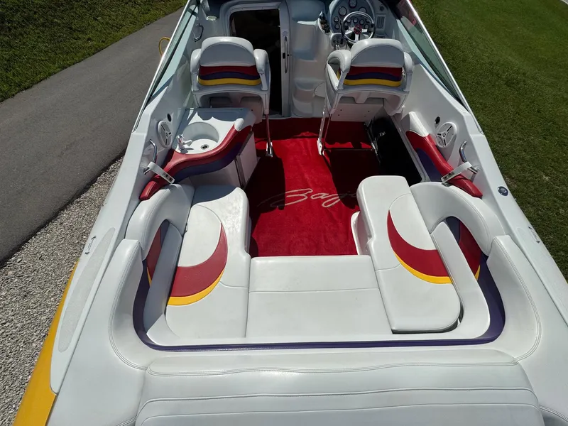Slide: The Image of 2002 Baja .38 Special boat interior with colorful seating and red carpet. - 5