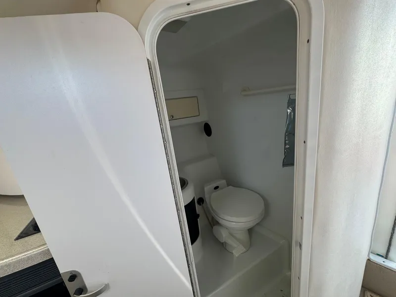 Slide: The Image of 2002 Baja .38 Special boat bathroom with white interior and compact toilet. - 8