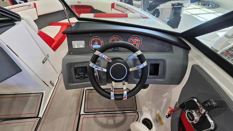 Slide: The Image of 2020 Cobalt CS22 boat interior with steering wheel and dashboard controls. - 14