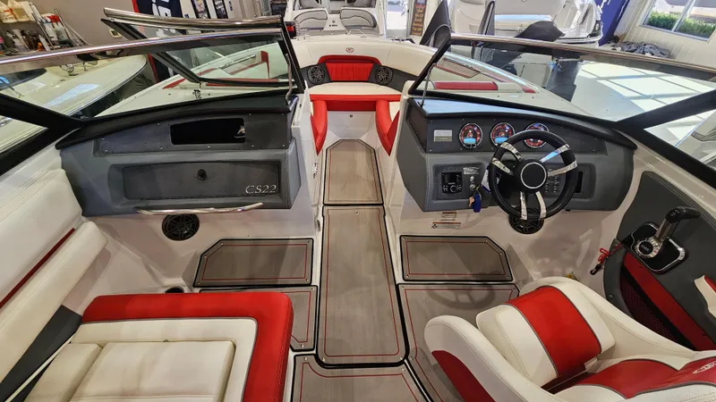 Slide: The Image of 2020 Cobalt CS22 boat interior with red and white seating, modern dashboard, and steering wheel. - 15