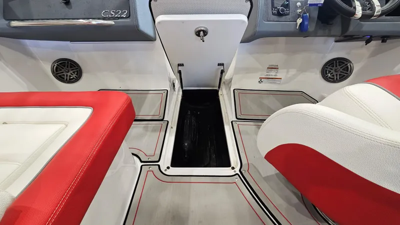 Slide: The Image of 2020 Cobalt CS22 boat interior with red and white seating and storage compartment. - 21