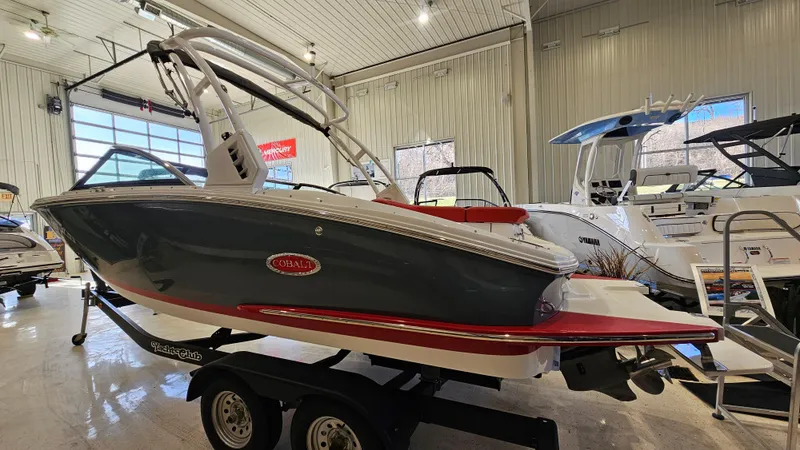 Slide: The Image of 2020 Cobalt CS22 boat on trailer in showroom, featuring sleek design and modern features. - 3