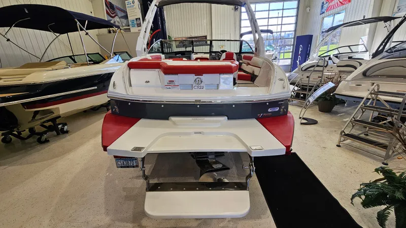 Slide: The Image of 2020 Cobalt CS22 boat in showroom, rear view with red and white seating. - 5