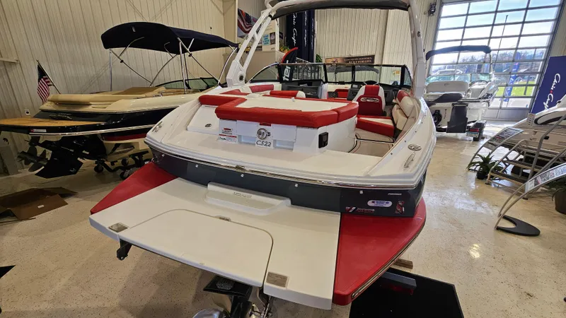 Slide: The Image of 2020 Cobalt CS22 boat with red and white interior, displayed in a showroom. - 6