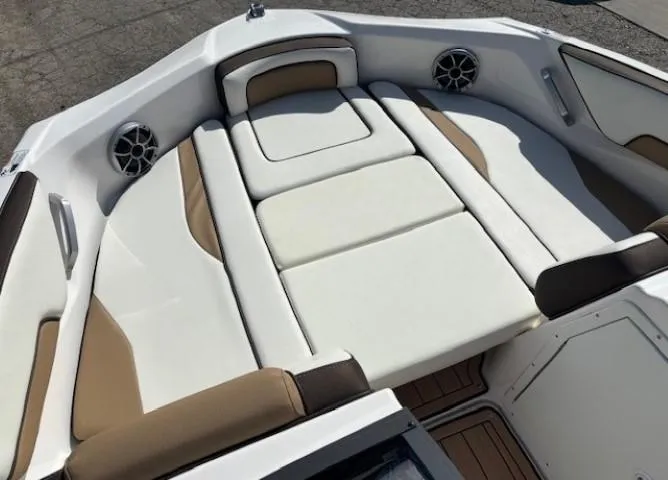 Slide: The Image of 2022 Yamaha Boats 195S interior with white and tan seating, featuring built-in speakers. - 10