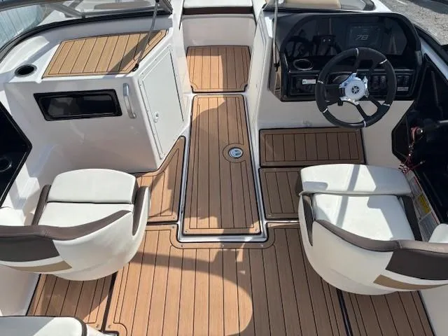 Slide: The Image of 2022 Yamaha Boats 195S interior with sleek seating and modern dashboard design. - 11