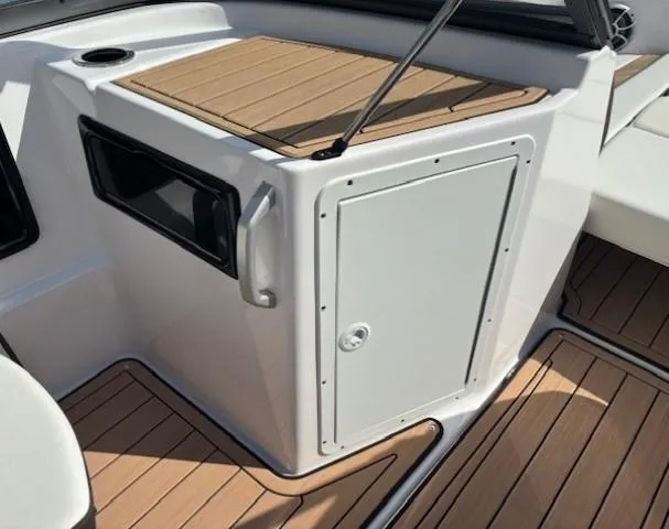 Slide: The Image of 2022 Yamaha Boats 195S interior with wood accents and storage compartment. - 13