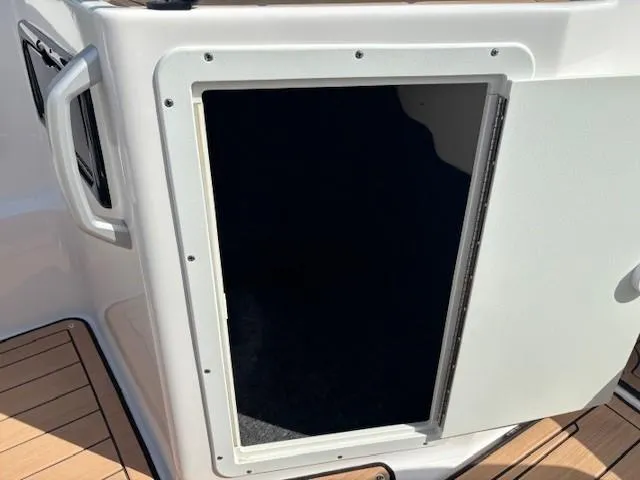 Slide: The Image of 2022 Yamaha Boats 195S storage compartment with open door, showcasing interior space. - 14