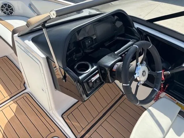 Slide: The Image of 2022 Yamaha Boats 195S cockpit with steering wheel and wood-style flooring. - 15