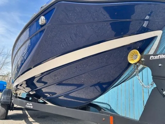 Slide: The Image of 2022 Yamaha Boats 195S in blue on trailer, showcasing sleek hull design. - 2