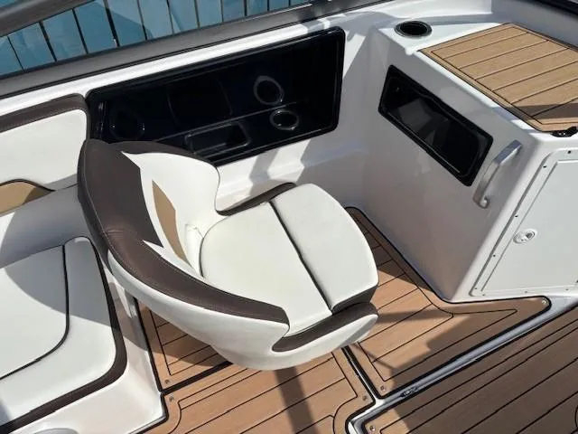 Slide: The Image of 2022 Yamaha Boats 195S interior with white seating and wood accents. - 20