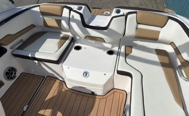 Slide: The Image of 2022 Yamaha Boats 195S interior with tan and white seating, featuring sleek design and wood accents. - 24