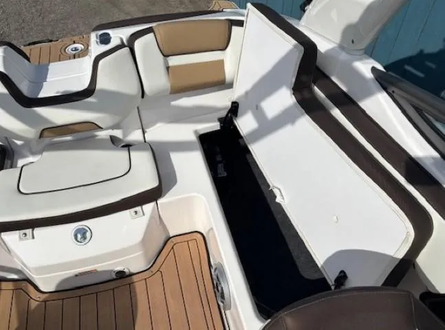 Slide: The Image of 2022 Yamaha Boats 195S interior with open storage compartment and cushioned seating. - 25