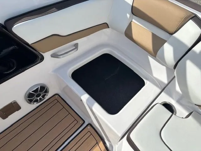 Slide: The Image of 2022 Yamaha Boats 195S interior seating with storage, speaker, and cup holder. - 26
