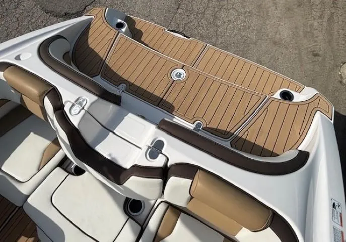 Slide: The Image of 2022 Yamaha Boats 195S interior with tan and white seating, featuring a sleek design. - 28