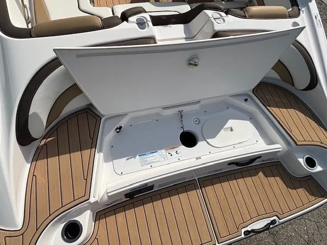 Slide: The Image of 2022 Yamaha Boats 195S swim platform with open storage compartment, featuring teak-style flooring. - 29