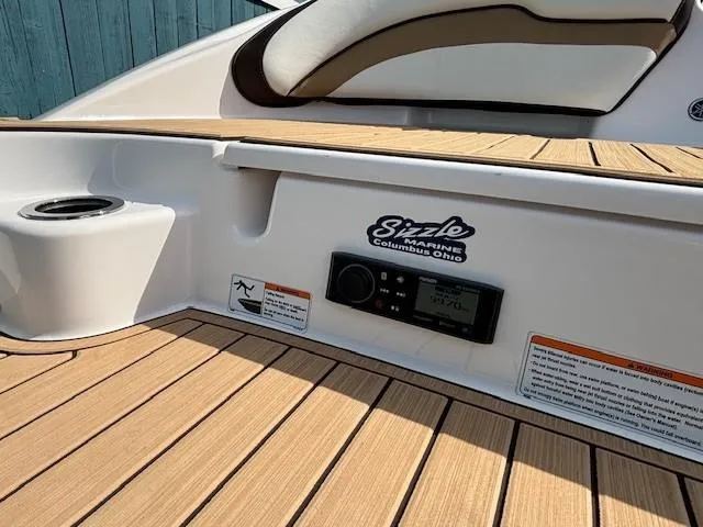 Slide: The Image of 2022 Yamaha Boats 195S deck with teak flooring and audio controls. - 30