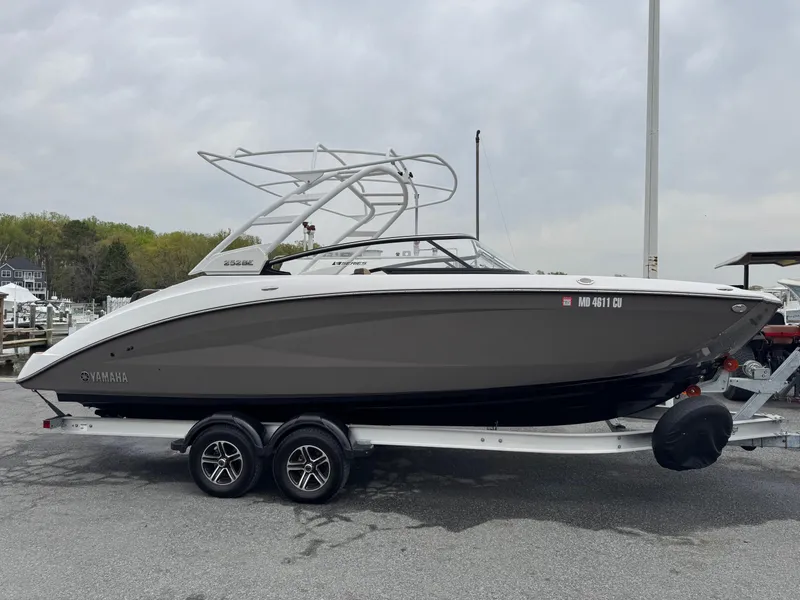 Slide: The Image of 2023 Yamaha Boats 252SE on trailer, sleek design, parked outdoors. - 1