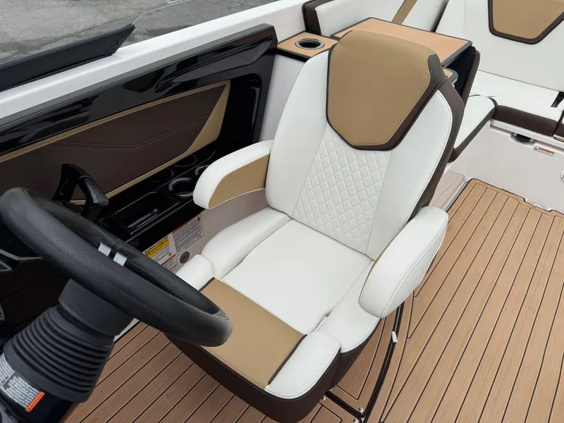 Slide: The Image of 2023 Yamaha Boats 252SE cockpit with luxurious seating and modern steering wheel design. - 3