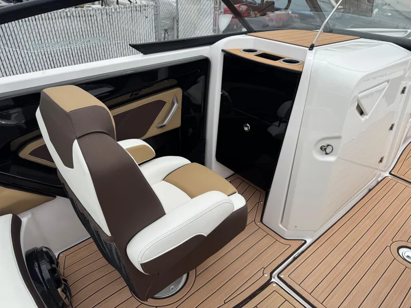 Slide: The Image of 2023 Yamaha Boats 252SE interior with sleek seating and modern dashboard design. - 9