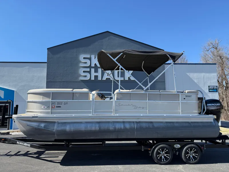Slide: The Image of 2019 South Bay 222CR pontoon boat on trailer outside Ski Shack. - 0