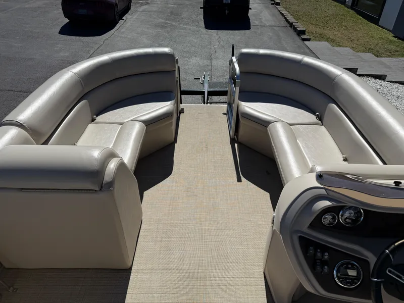 Slide: The Image of 2019 South Bay 222CR pontoon boat interior with beige seating and control panel. - 10