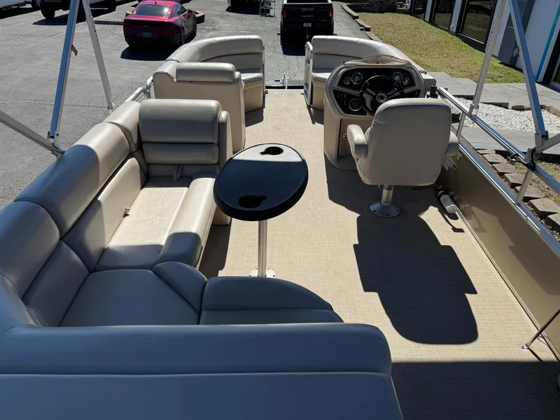 Slide: The Image of 2019 South Bay 222CR pontoon boat interior with beige seating and steering console. - 11