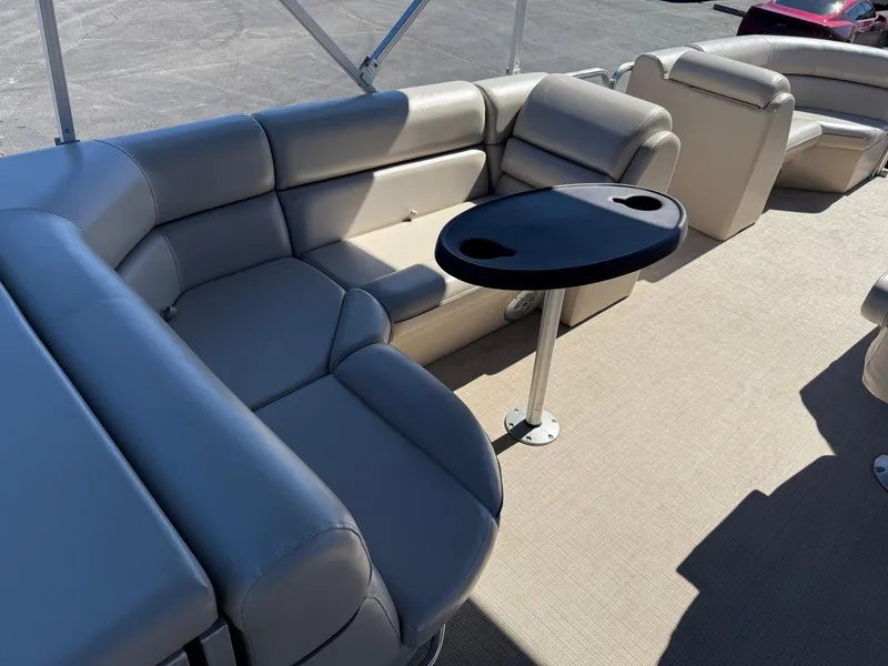 Slide: The Image of 2019 South Bay 222CR pontoon boat interior with beige seating and a small table. - 13