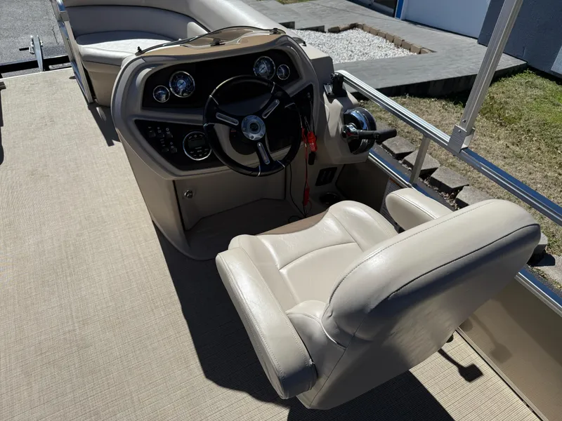 Slide: The Image of 2019 South Bay 222CR boat interior with steering wheel and beige seating. - 15