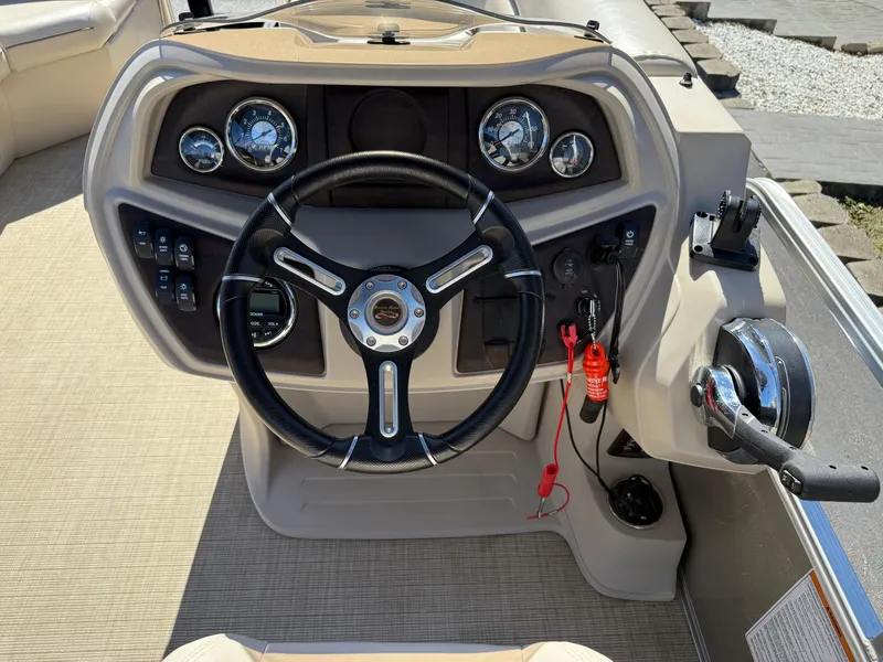 Slide: The Image of Steering console of a 2019 South Bay 222CR boat with gauges and controls. - 17