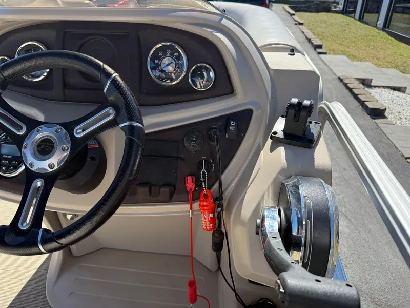 Slide: The Image of 2019 South Bay 222CR boat dashboard with steering wheel and control panel. - 19
