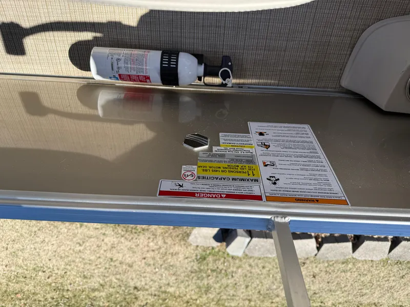 Slide: The Image of 2019 South Bay 222CR boat interior with safety labels and fire extinguisher. - 20