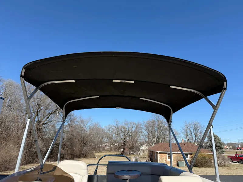 Slide: The Image of 2019 South Bay 222CR pontoon boat with canopy under clear blue sky. - 22