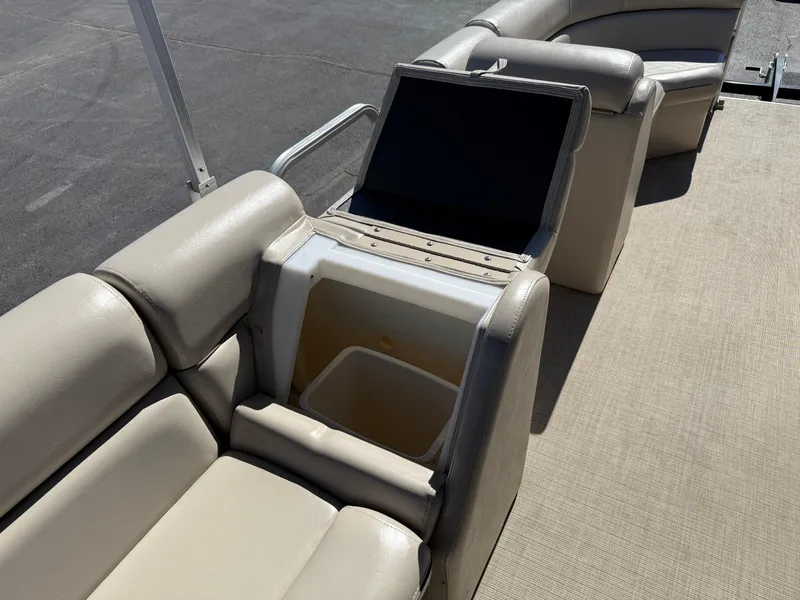 Slide: The Image of 2019 South Bay 222CR pontoon boat interior with beige seating and storage compartment. - 9