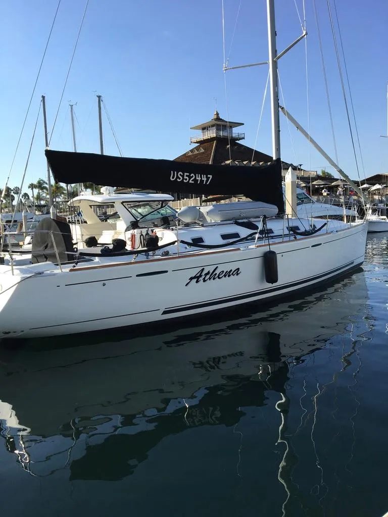 Slide: The Image of 2005 Beneteau First 44.7 sailboat docked in marina, clear sky, calm water. - 1